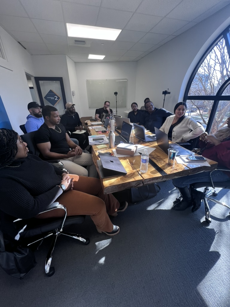 Community members working through solicitations around a conference table